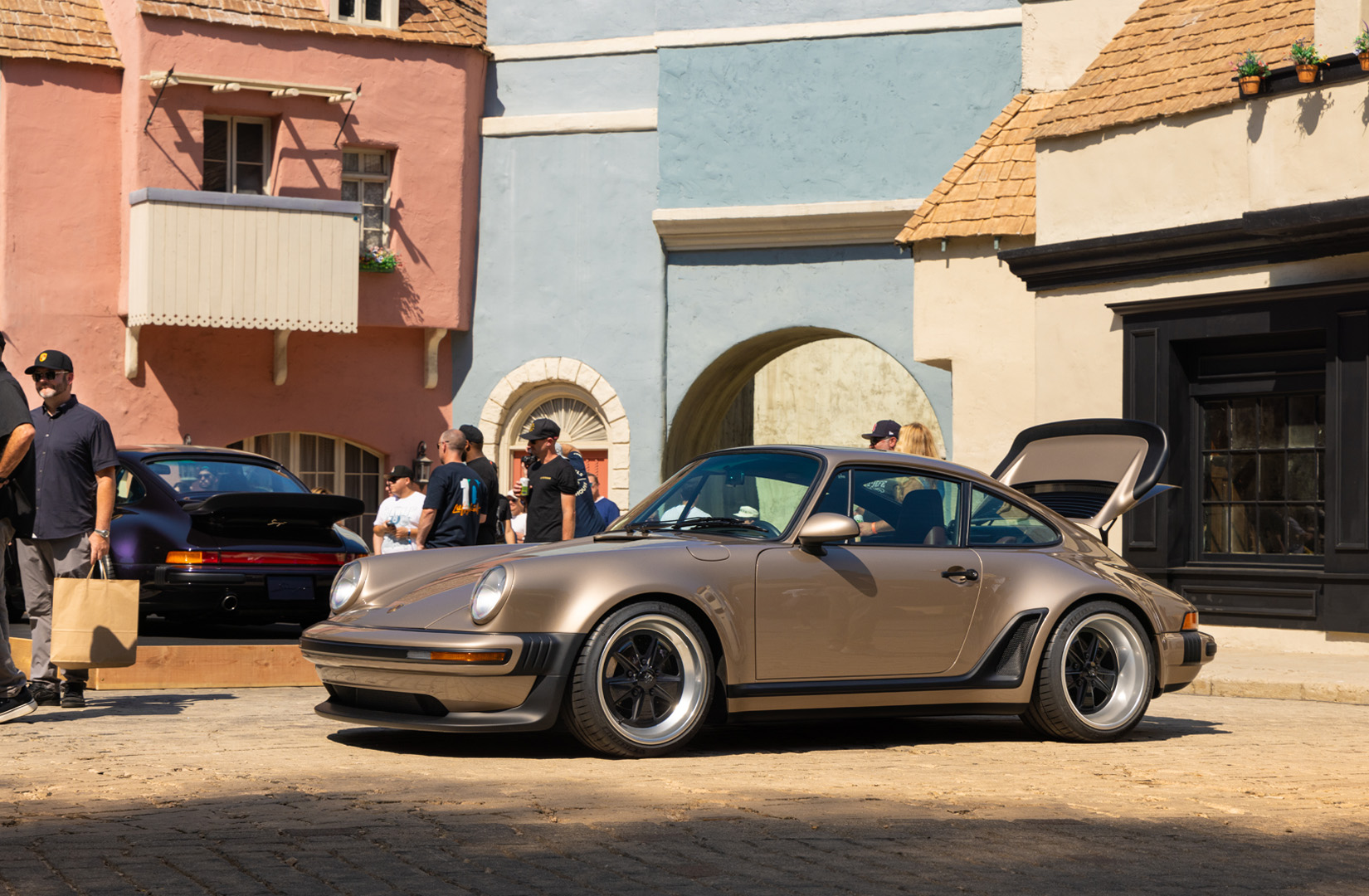 Brown show car Porsche parked with trunk lid open