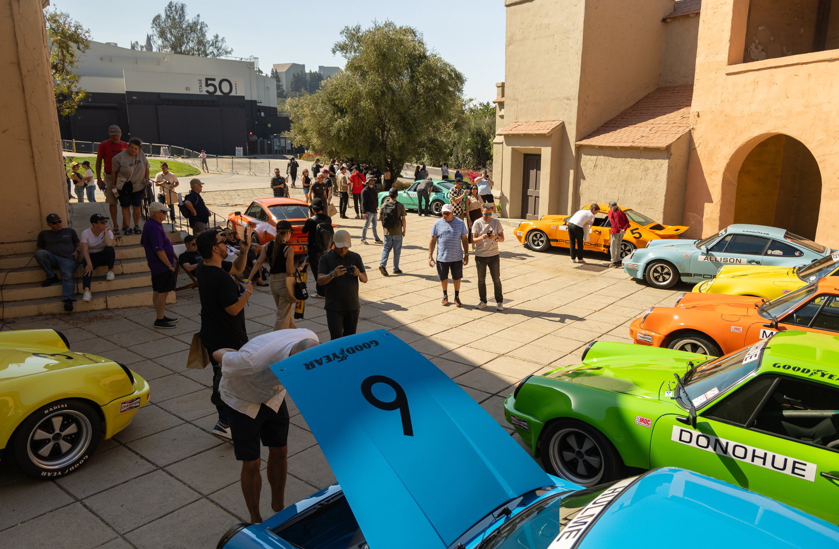 people gathered around old classic cars